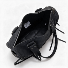 Side view of black top handle crossbody satchel
