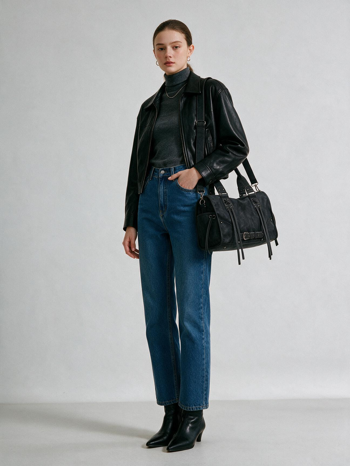 Woman wearing the black belted satchel bag