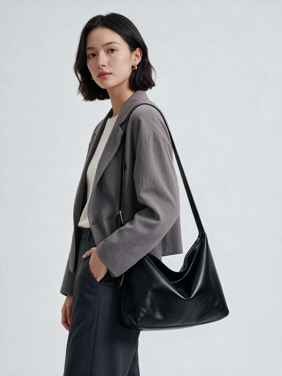 Woman wearing the black hobo crossbody bag with an adjustable strap