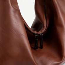 Close-up of the brown tote bag material and hardware