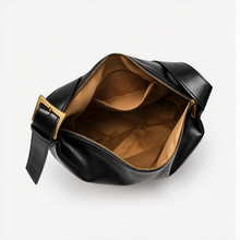 Open zip top of black hobo bag showing polyester lining and interior pocket