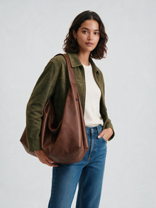 Woman wearing the brown shoulder tote bag with casual outfit
