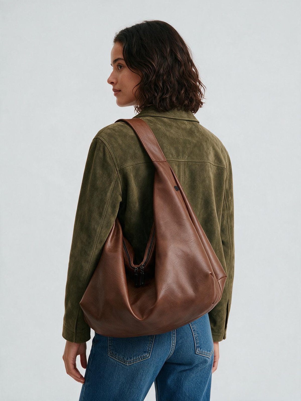 Back view of woman wearing the brown shoulder tote bag