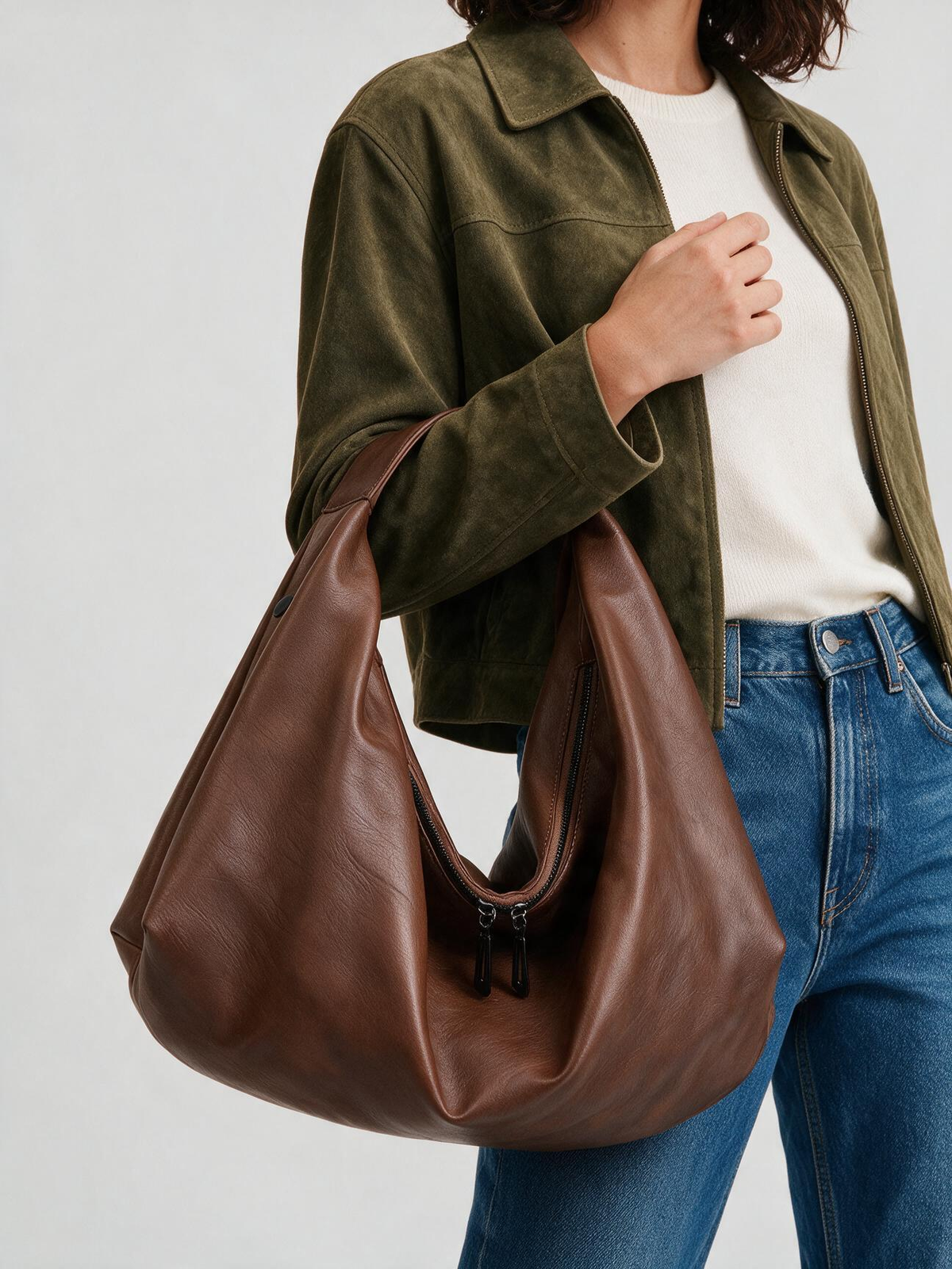 Woman carrying the brown slouchy shoulder tote bag