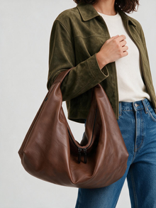 Woman carrying the brown slouchy shoulder tote bag