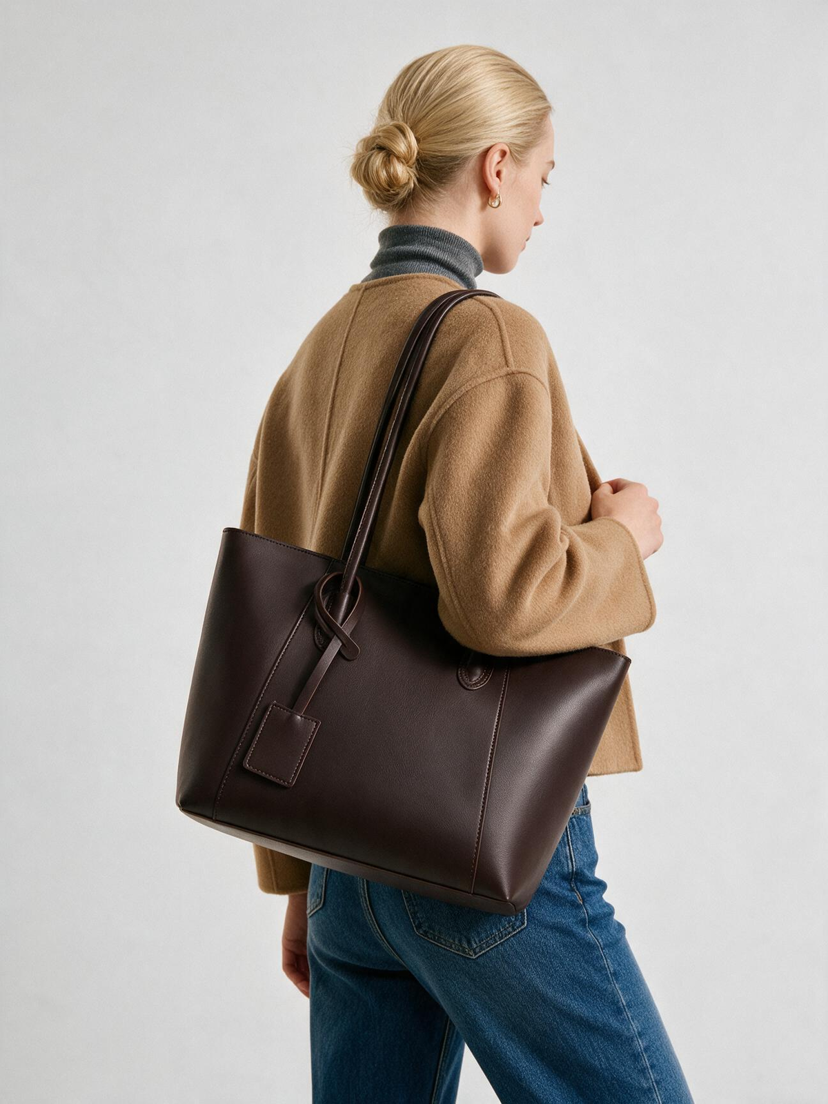 Back view of woman wearing chocolate brown shoulder tote
