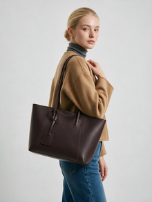 Woman wearing a chocolate brown tote over her shoulder