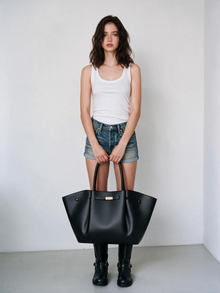 Front styling view of the black winged tote bag