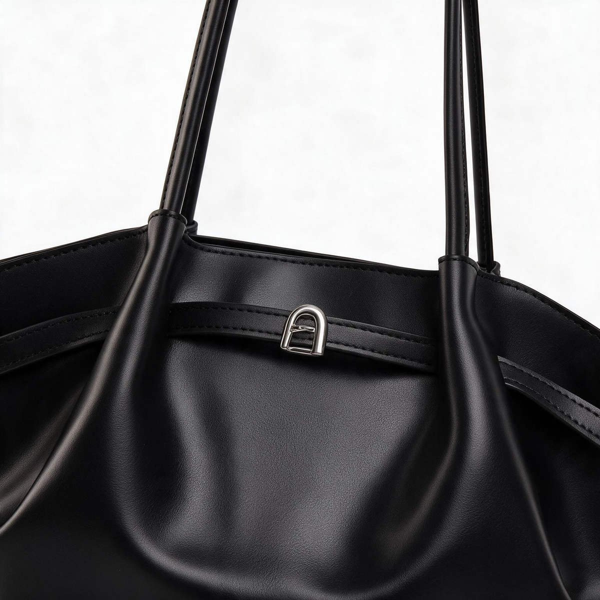Close-up of black tote bag exterior and handle
