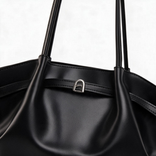 Close-up of black tote bag exterior and handle