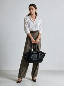Black shoulder tote bag worn with everyday outfit