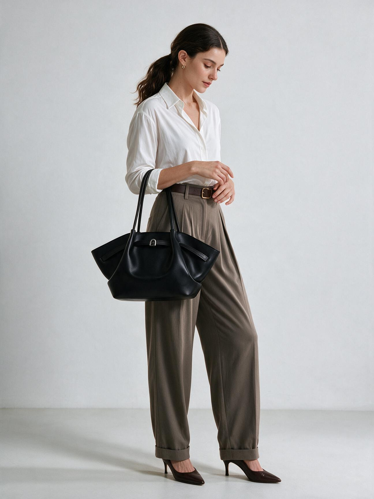 Model styling the black shoulder tote bag