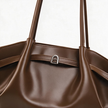 Brown tote bag close-up of handle and front detail