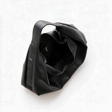 Open black slouchy tote showing the interior