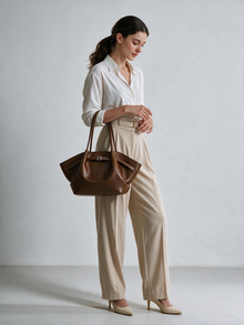 Woman styling the brown shoulder tote bag