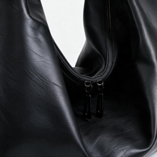 Black slouchy tote bag close-up of material and opening