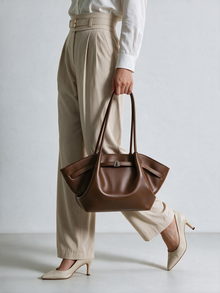Brown shoulder tote bag carried at the side