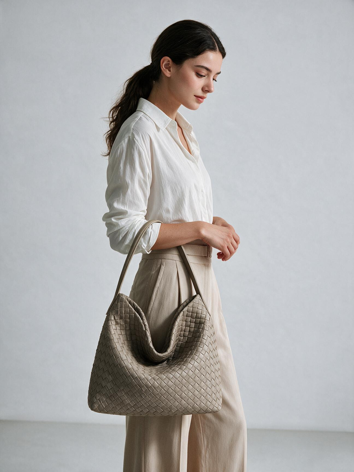 Model wearing the taupe woven-look hobo bag over her shoulder
