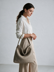 Model wearing the taupe woven-look hobo bag over her shoulder