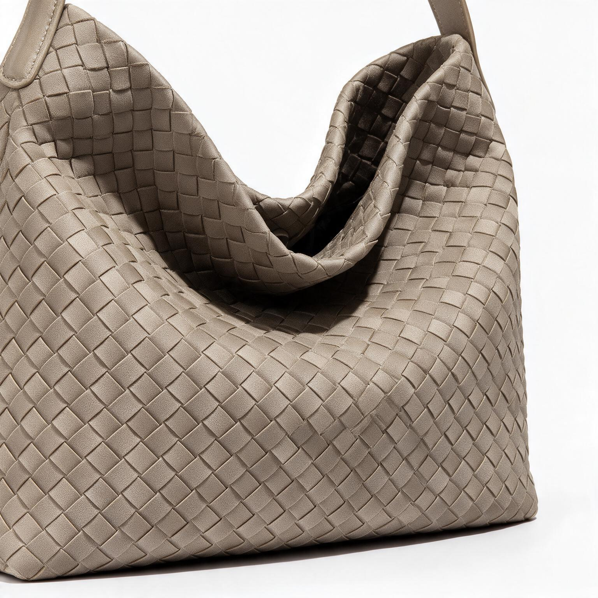 Close-up of the taupe bag's woven-look texture and slouchy opening